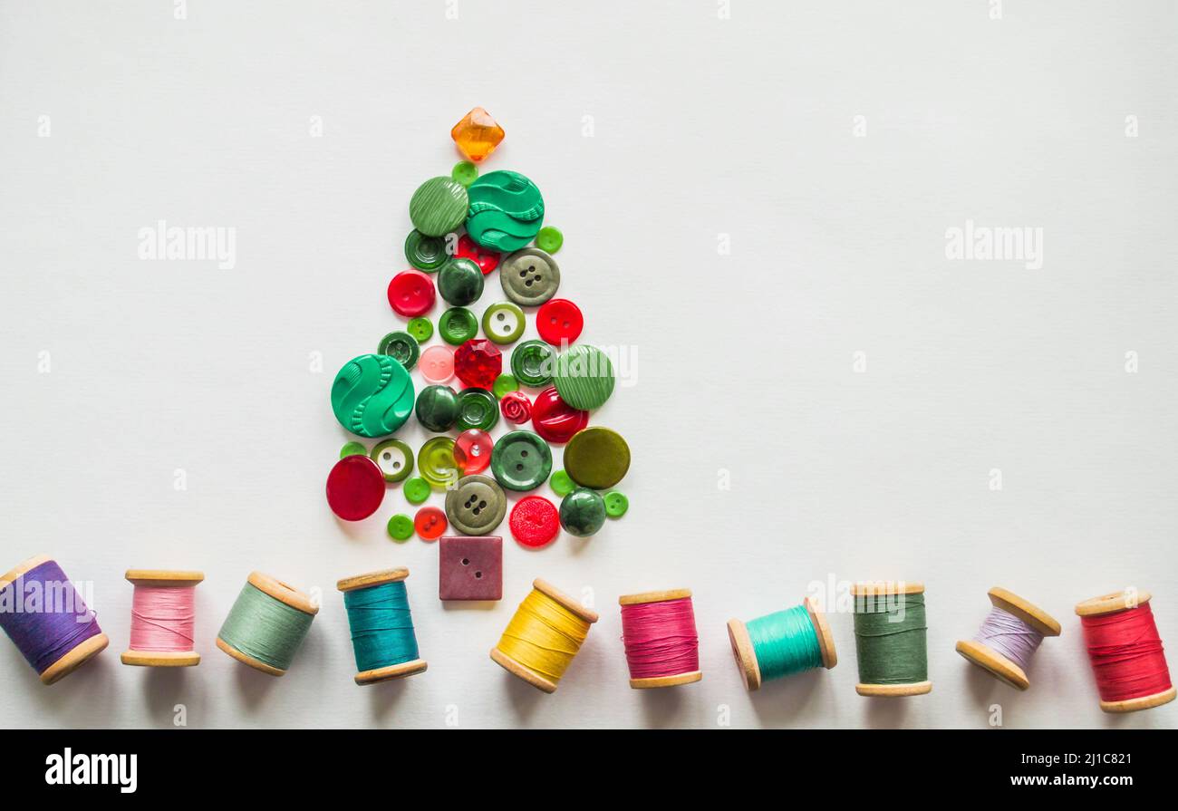 Tree made of buttons green, red color. Multicolored threads with wooden ...
