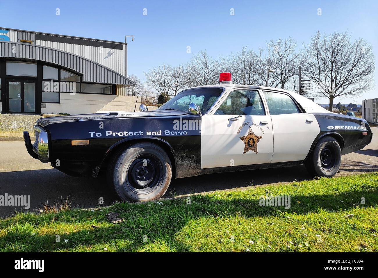 Pofolk, USA - March 23 2022: Old Dodge Monaco highway patrol car parked in font of a shop. Stock Photo