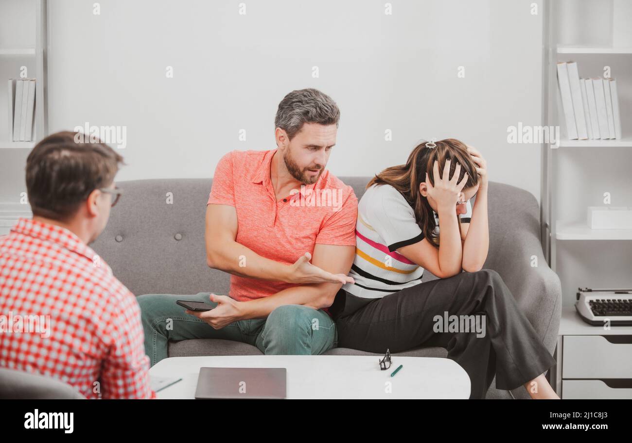 Social worker psychologist talking to young couple. Couple telling the
