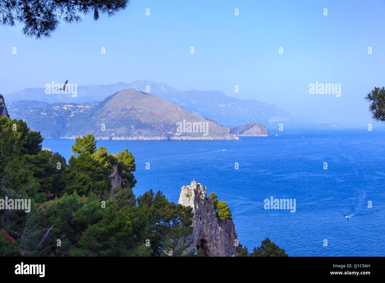 Capri Island. Magnificent view from the sea on the rocky shores of the island of Capri and the mountains surrounding the Amalfi coast. Stock Photo