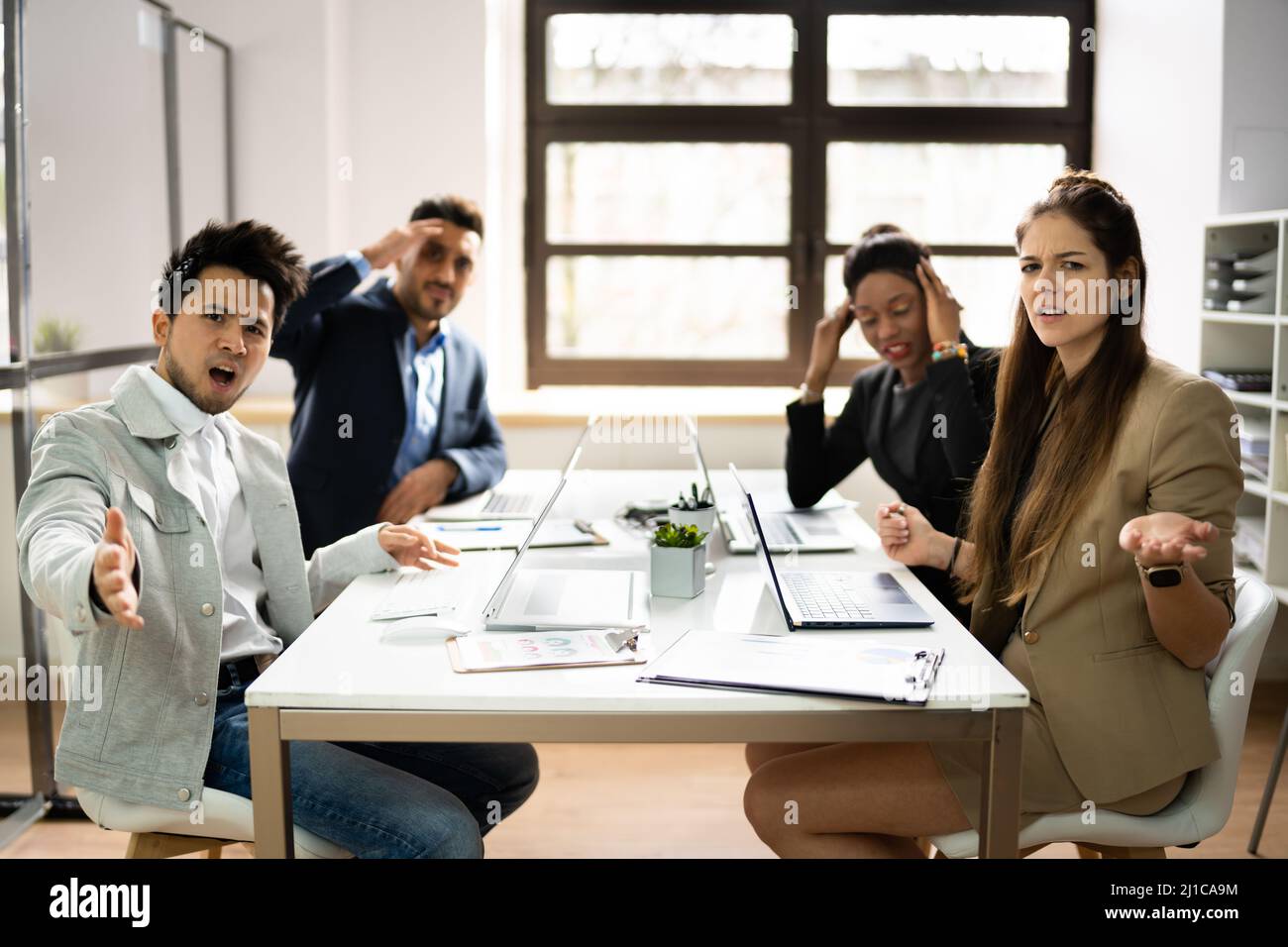 Angry Executives At Workplace Complaining. Worker Fight Stock Photo