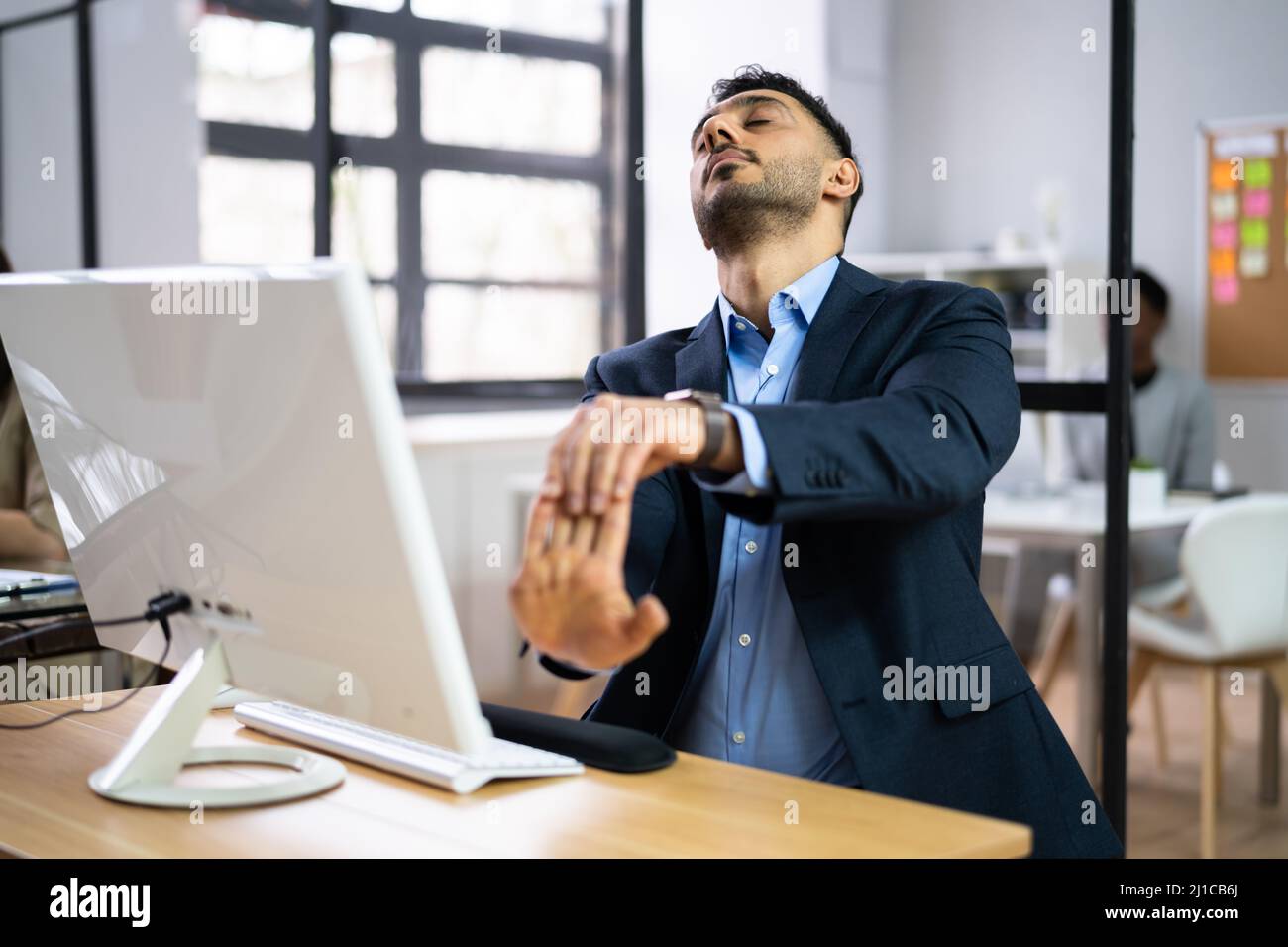 Work From Home Stretch Exercise At Computer Desk Stock Photo Alamy