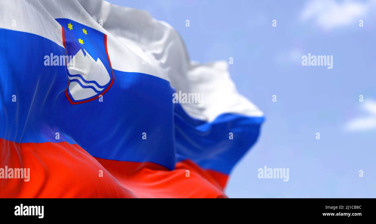 Detail of the national flag of Slovenia waving in the wind on a clear day. Slovenia is a country in Central Europe. Selective focus. Stock Photo