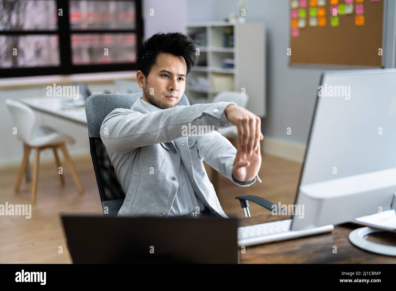 Work From Home Stretch Exercise At Computer Desk Stock Photo Alamy