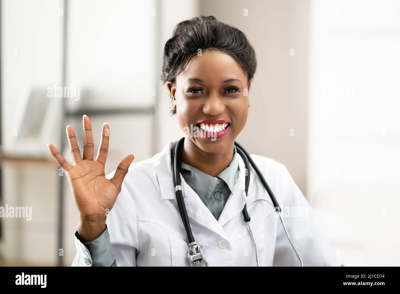 Doctor Waving In Online Video Call Meeting Stock Photo