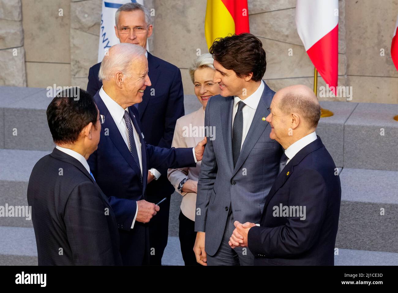 Brussels, Belgium. 24th Mar, 2022. U.S President Joe Biden, left, chats with Canadian Prime Minister Justin Trudeau following a group photo during the emergency meeting of the G7 nations at NATO headquarters, March 24, 2022 in Brussels, Belgium. Standing with Biden from left to right are: Japanese Prime Minister Fumio Kishida, President Joe Biden, NATO Secretary General Jens Stoltenberg, European Commission President Ursula von der Leyen, Canadian Prime Minister Justin Trudeau and German Chancellor Olaf Scholz. Credit: Adam Schultz/White House Photo/Alamy Live News Stock Photo