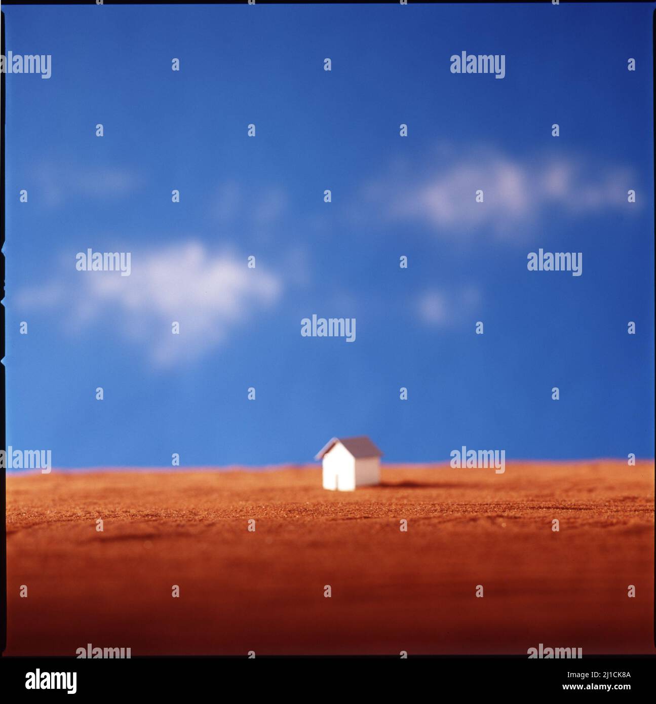 Studio still life of miniature house on blue sky background Stock Photo ...