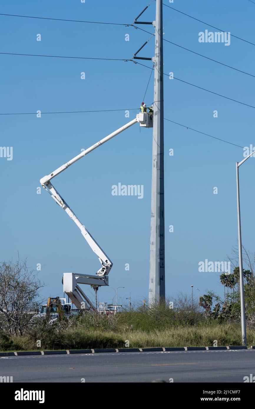 Electrical construction workers or linemen working in an elevated