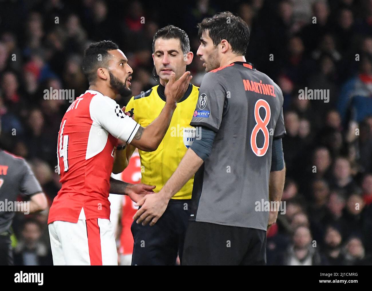 LONDON, ENGLAND - MARCH 7, 2017: Theo Walcott (L) of Arsenal and Javi Martinez (R) of Bayern argue in front of Greek FIFA referee Tasos Sidiropoulos during the second leg of the UEFA Champions League Round of 16 game between Arsenal FC and Bayern Munchen at Emirates Stadium. Copyright: Cosmin Iftode/Picstaff Stock Photo