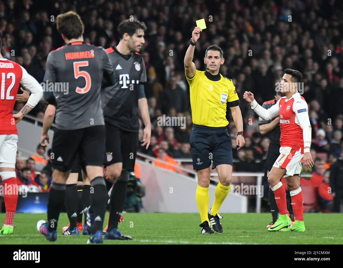 LONDON, ENGLAND - MARCH 7, 2017: Greek FIFA referee Tasos Sidiropoulos shows a yellow card during the second leg of the UEFA Champions League Round of 16 game between Arsenal FC and Bayern Munchen at Emirates Stadium. Copyright: Cosmin Iftode/Picstaff Stock Photo