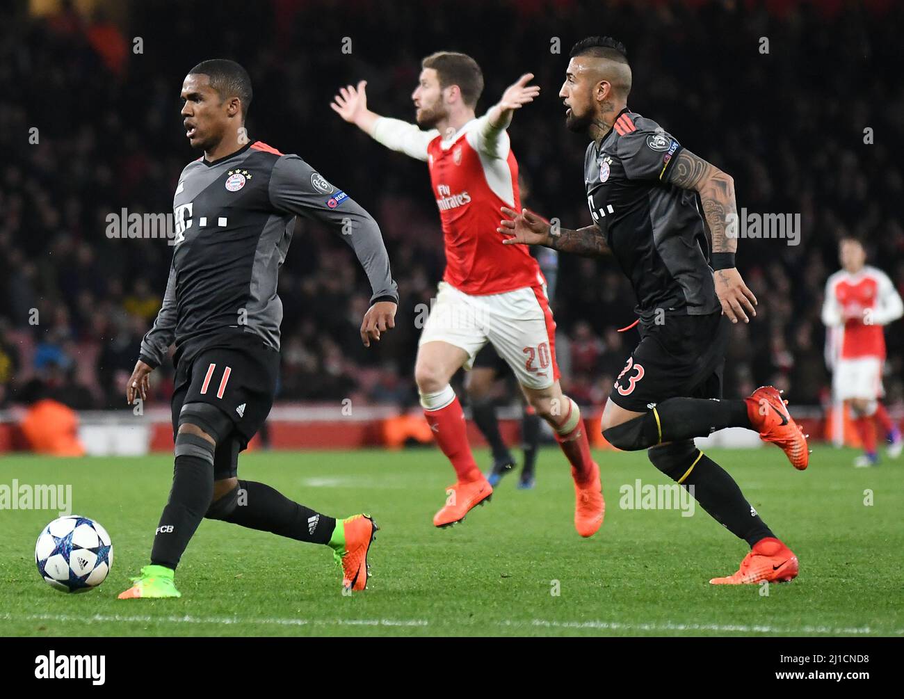 LONDON, ENGLAND - MARCH 7, 2017: Douglas Costa (L) fo Bayern pictured in action during the second leg of the UEFA Champions League Round of 16 game between Arsenal FC and Bayern Munchen at Emirates Stadium. Copyright: Cosmin Iftode/Picstaff Stock Photo