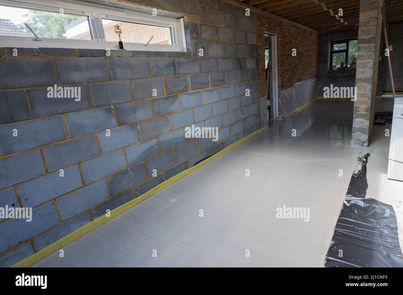 Screeding over underfloor heating pipes in residential property Stock