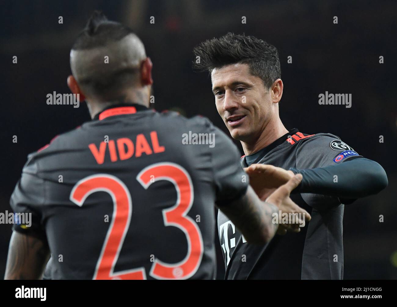LONDON, ENGLAND - MARCH 7, 2017: Arturo Vidal of Bayern celebrates with Robert Lewandowski (R) after he scored a goal during the second leg of the UEFA Champions League Round of 16 game between Arsenal FC and Bayern Munchen at Emirates Stadium.v Stock Photo