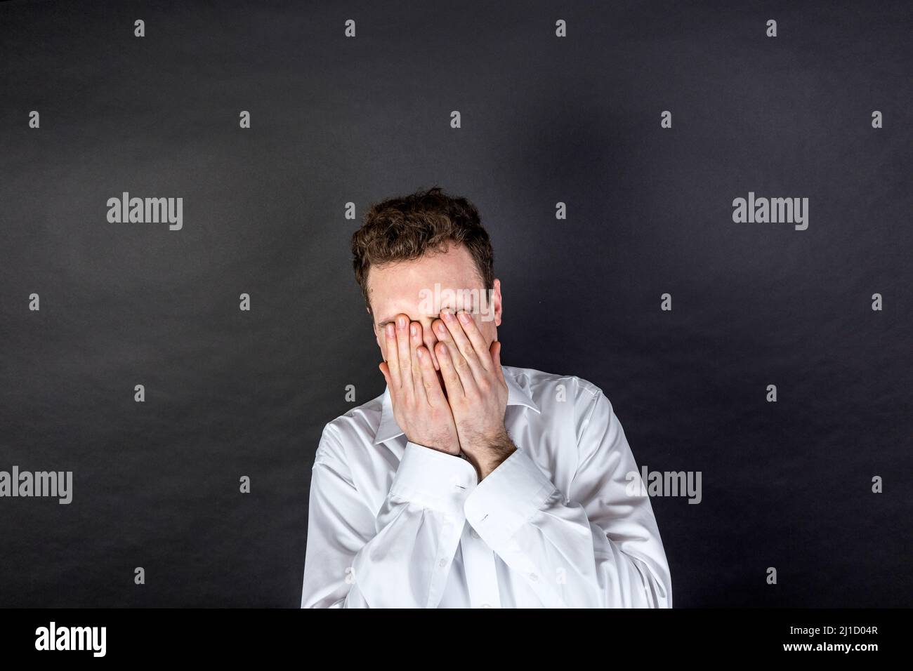 portrait of sad young man isolated on black Stock Photo - Alamy