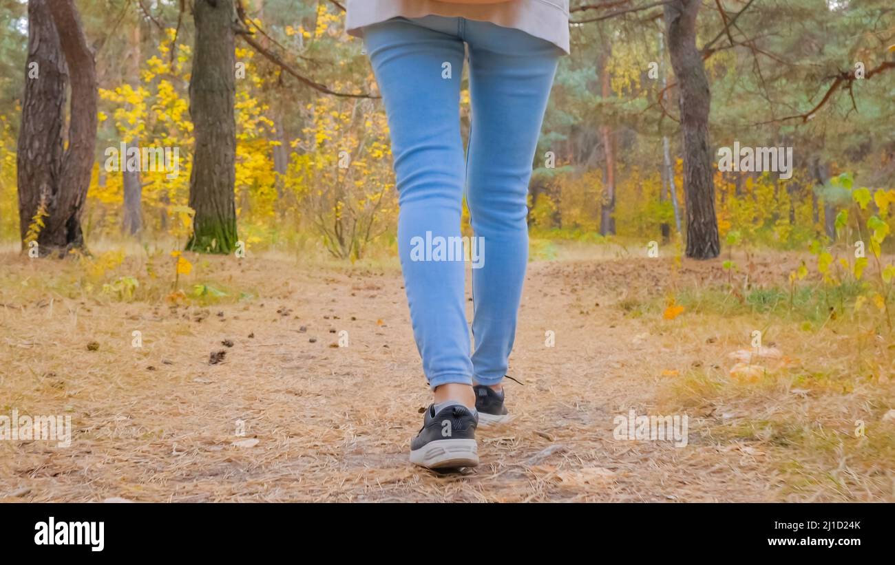 Woman legs walking on road in autumn park - close up Stock Photo - Alamy