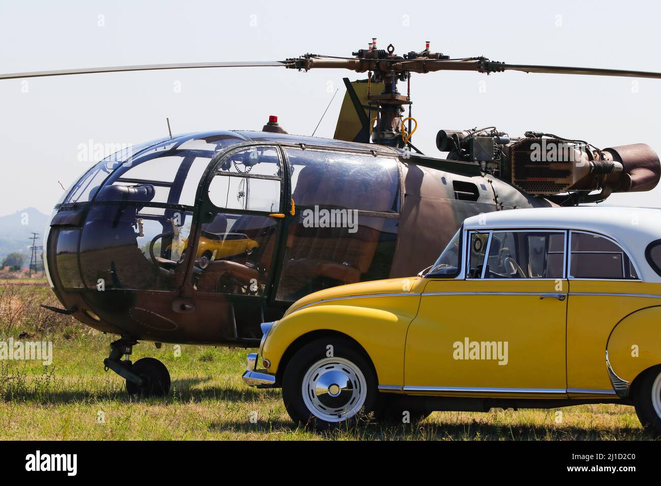 Light Military Helicopter With Yellow Classic Car Stock Photo