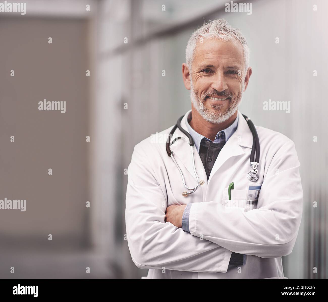 Let me help take care of your overall health. Portrait of a mature male doctor standing in a hospital. Stock Photo