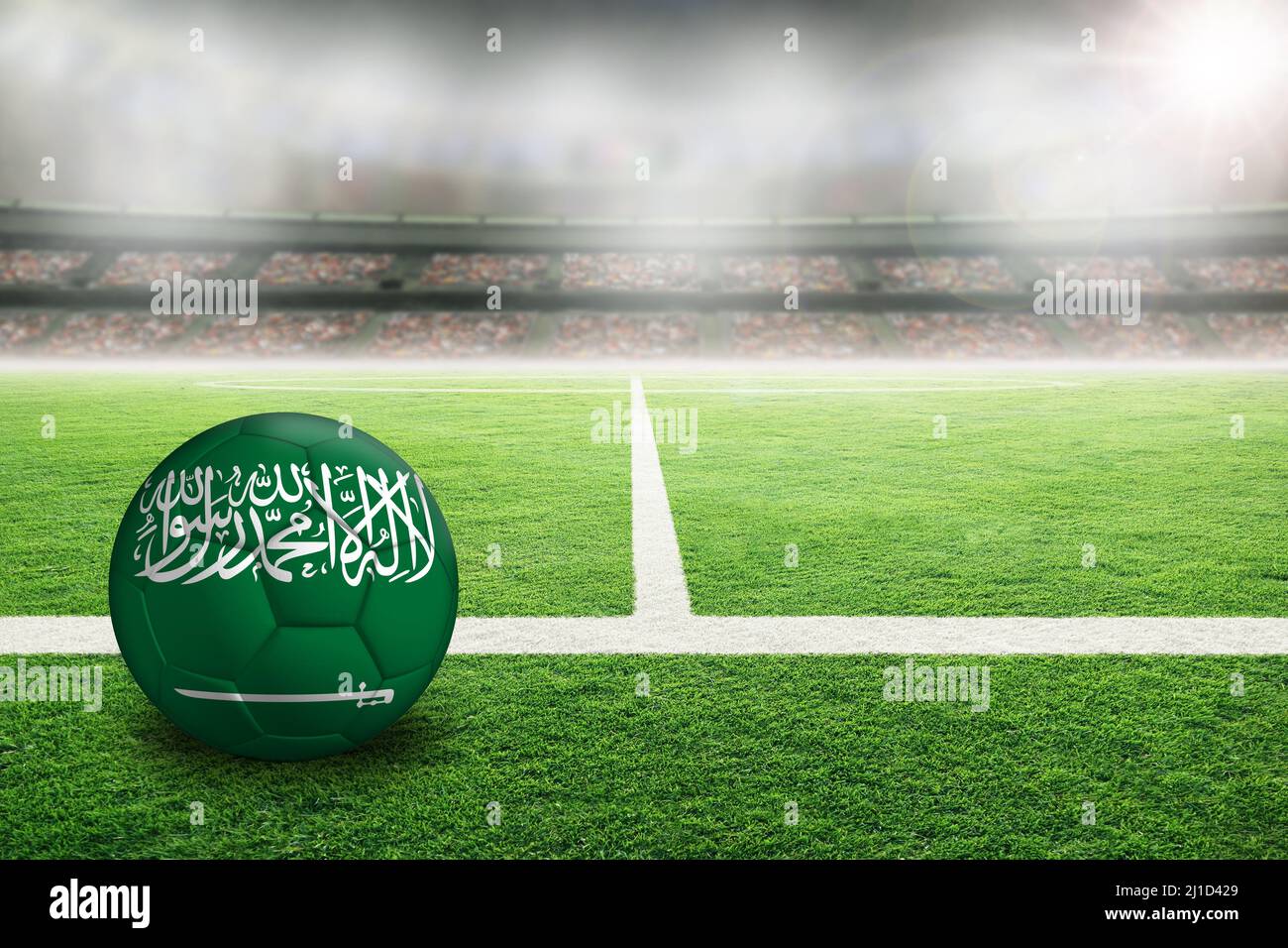 Football in brightly lit outdoor stadium with painted flag of Saudi Arabia. Focus on foreground and soccer ball with shallow depth of field on backgro Stock Photo