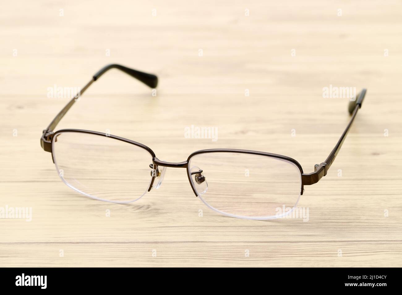 Stylish eyesight glasses on wooden table Stock Photo