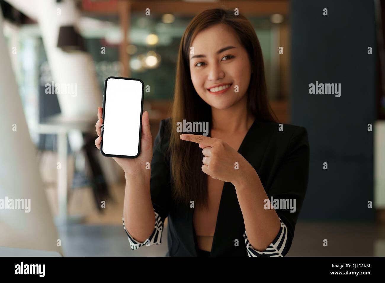 Woman showing smartphone with blank screen for advertise. Stock Photo