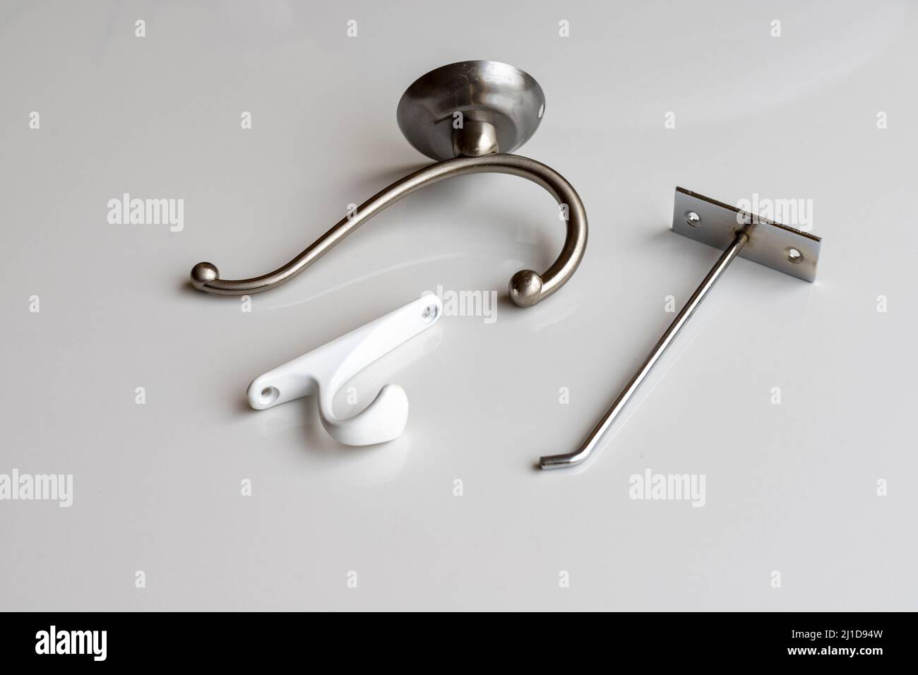 Different wall hooks on white background Stock Photo
