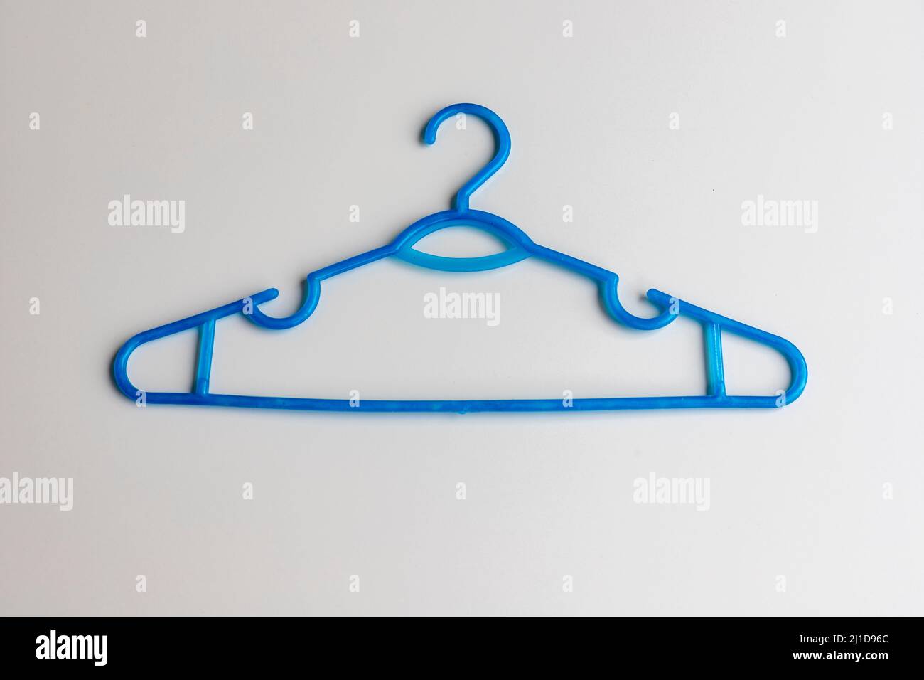Blue plastic hanger on white background Stock Photo