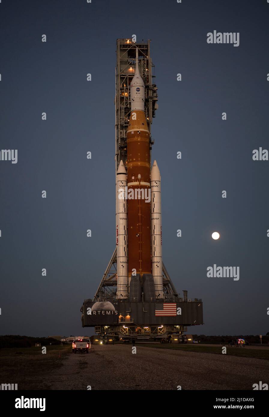 The Moon is seen rising behind NASAs Space Launch System (SLS) rocket with the Orion spacecraft aboard atop a mobile launcher as it rolls out to Launch Complex 39B for the first time, Thursday, March 17, 2022, at NASAs Kennedy Space Center in Florida. Ahead of NASAs Artemis I flight test, the fully stacked and integrated SLS rocket and Orion spacecraft will undergo a wet dress rehearsal at Launch Complex 39B to verify systems and practice countdown procedures for the first launch. Mandatory Credit: Aubrey Gemignani/NASA via CNP Stock Photo