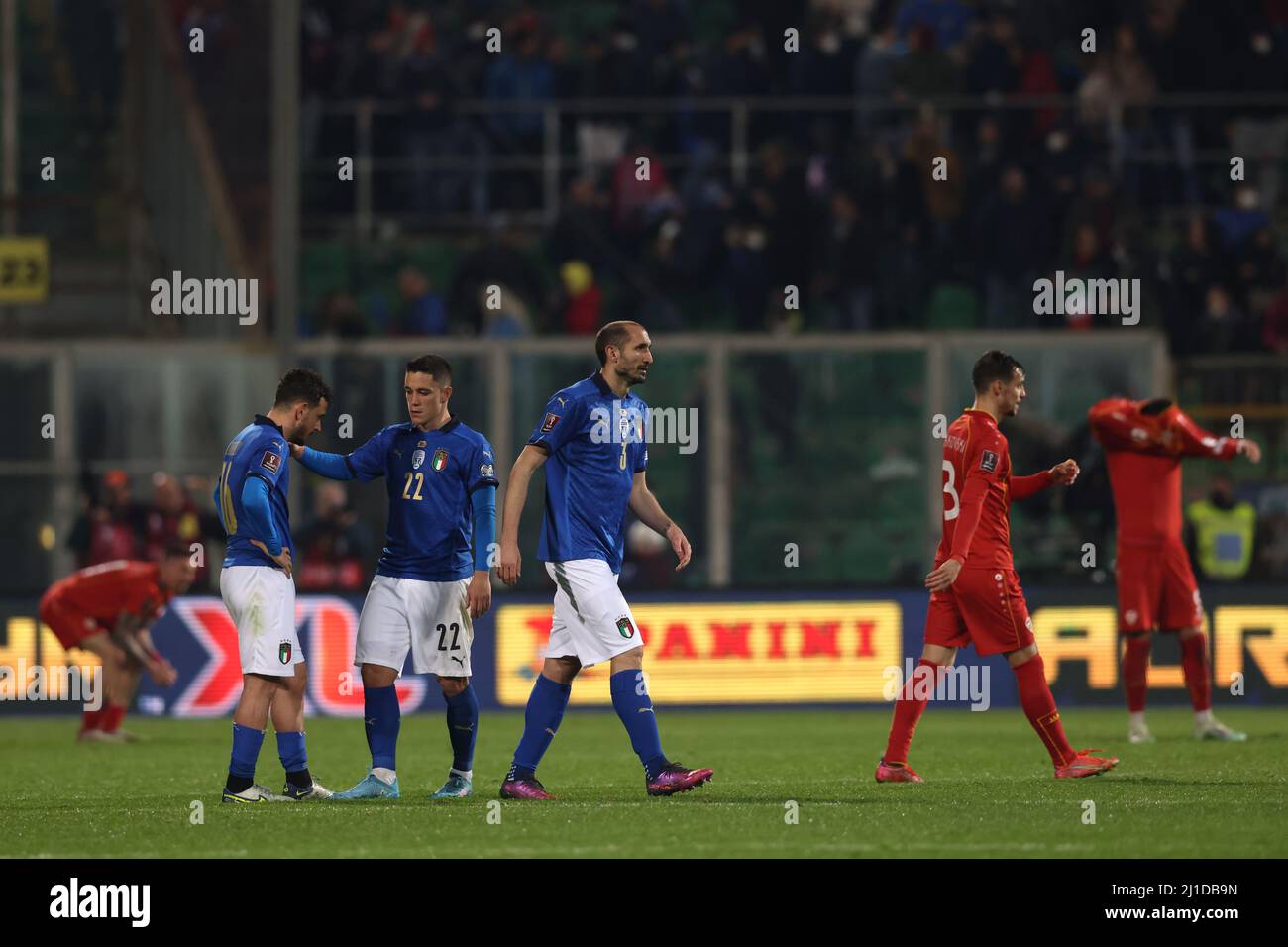 Palermo, Italy, 24th March 2022. Giorgio Chiellini of Italy walks away as team mate Giacomo Raspadori consoles Alessandro Florenzi following the final whistle of the FIFA World Cup 2022 - European Qualifying match at Renzo Barbera Stadium, Palermo. Picture credit should read: Jonathan Moscrop / Sportimage Stock Photo