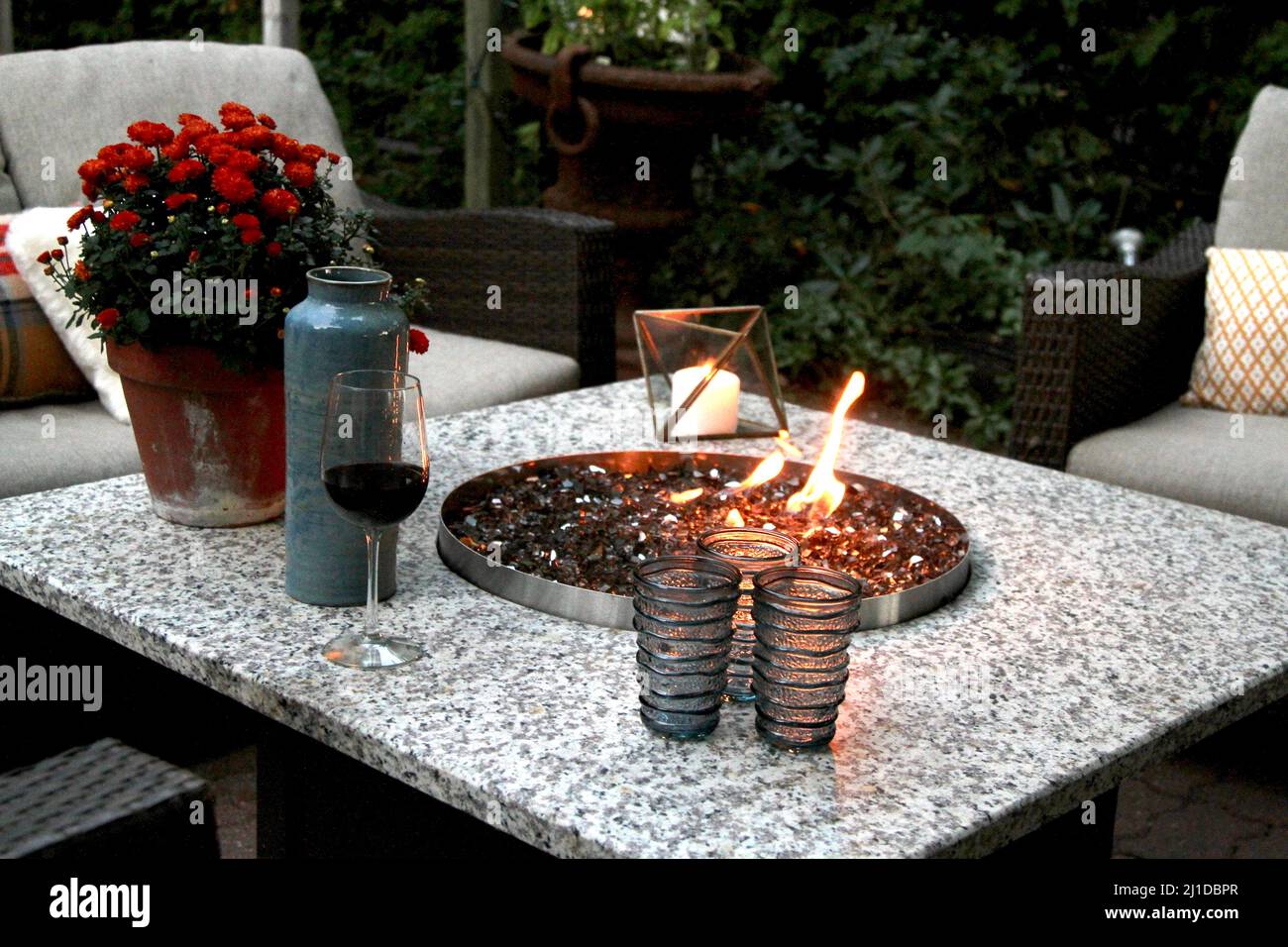Outdoor seating arrangement around a gas fire pit table in the fall Stock Photo