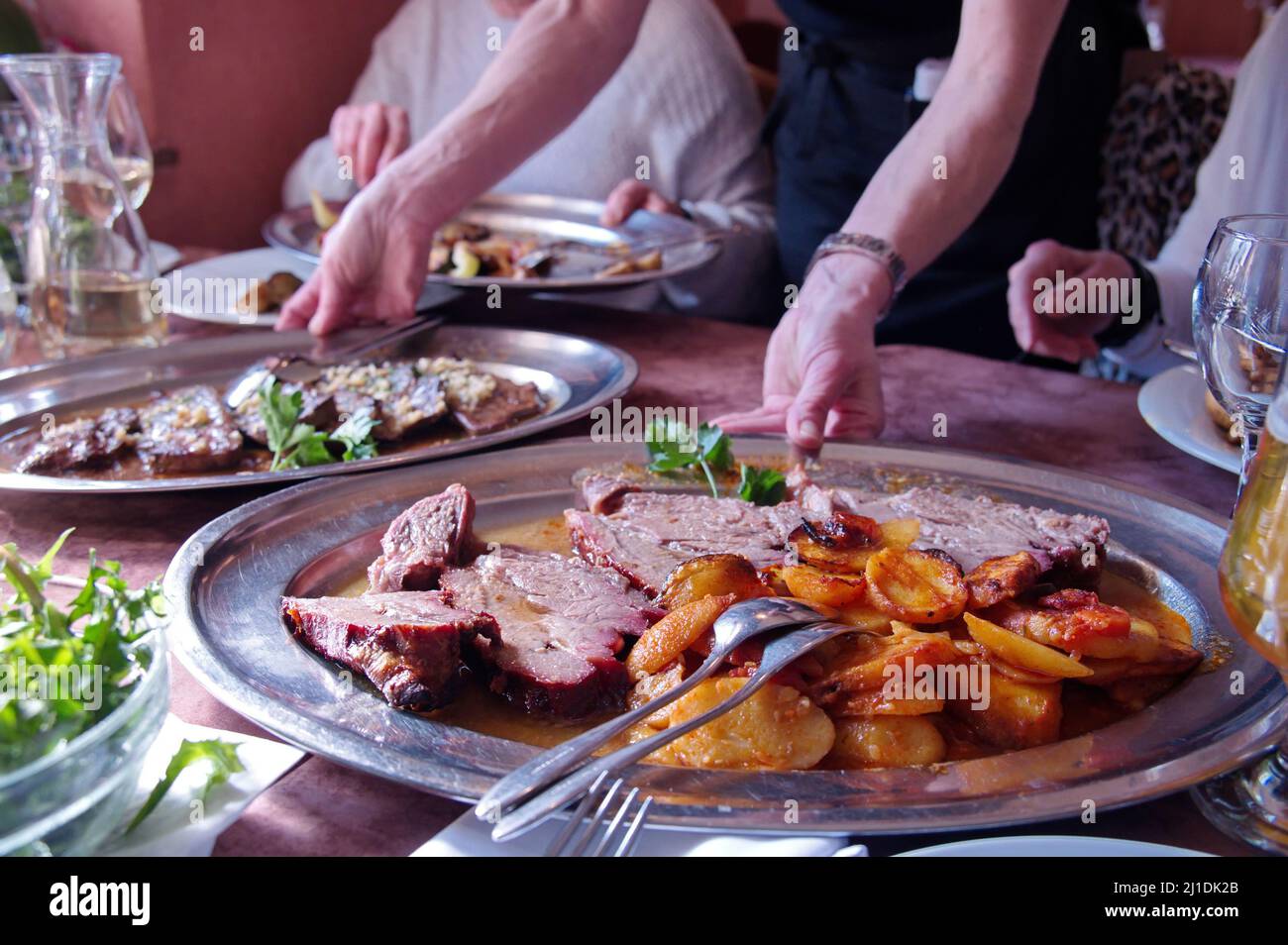 Various food with roasted meet, potatoes and vegetables on rustic table