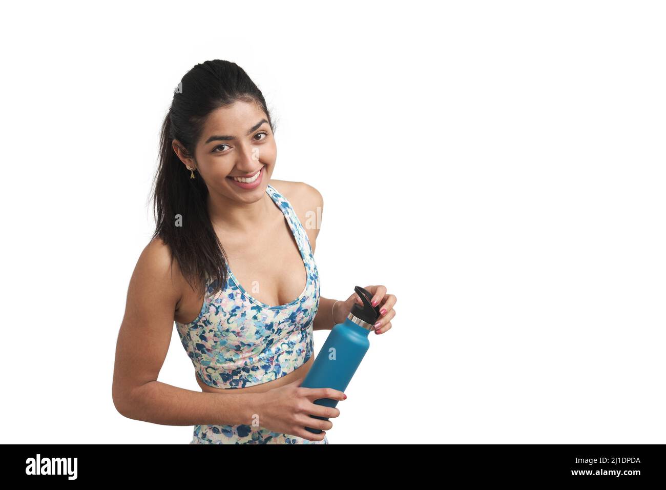 Venezuelan sportswoman smile and look at camera with a water bottle ...