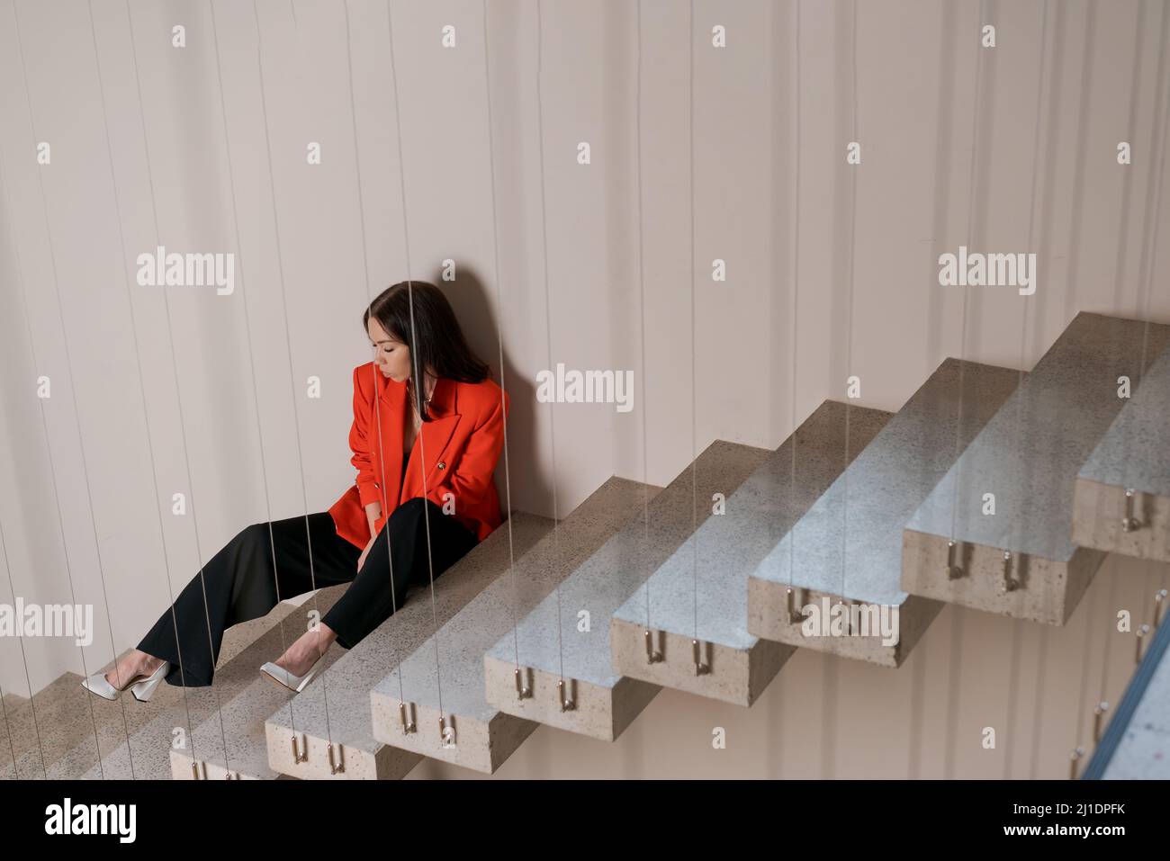Sad girl sitting on stairs hi-res stock photography and images - Alamy