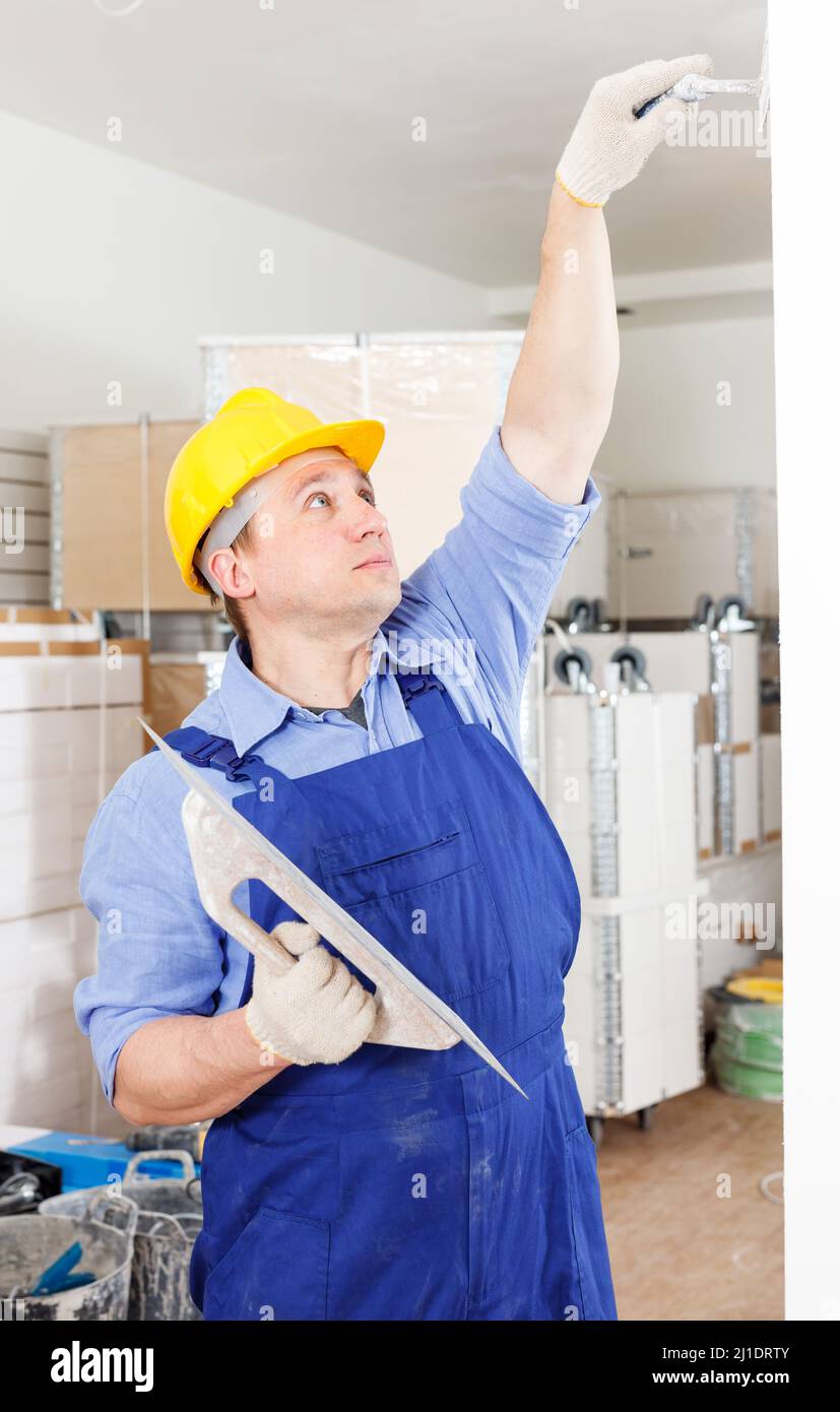 Plasterer working indoors Stock Photo - Alamy