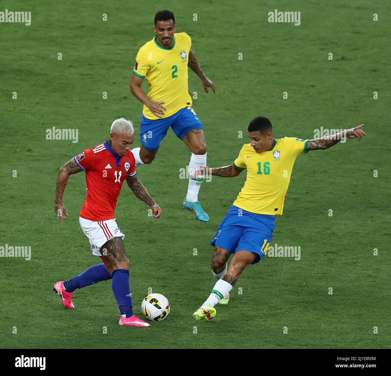 Rio De Janeiro. 24th Mar, 2022. Guilherme Arana (R) of Brazil vies with Eduardo Vargas (L) of Chile during the 2022 FIFA World Cup Qualifier between Brazil and Chile in Rio de Janeiro, Brazil on March 24, 2022. Credit: Wang Tiancong/Xinhua/Alamy Live News Stock Photo