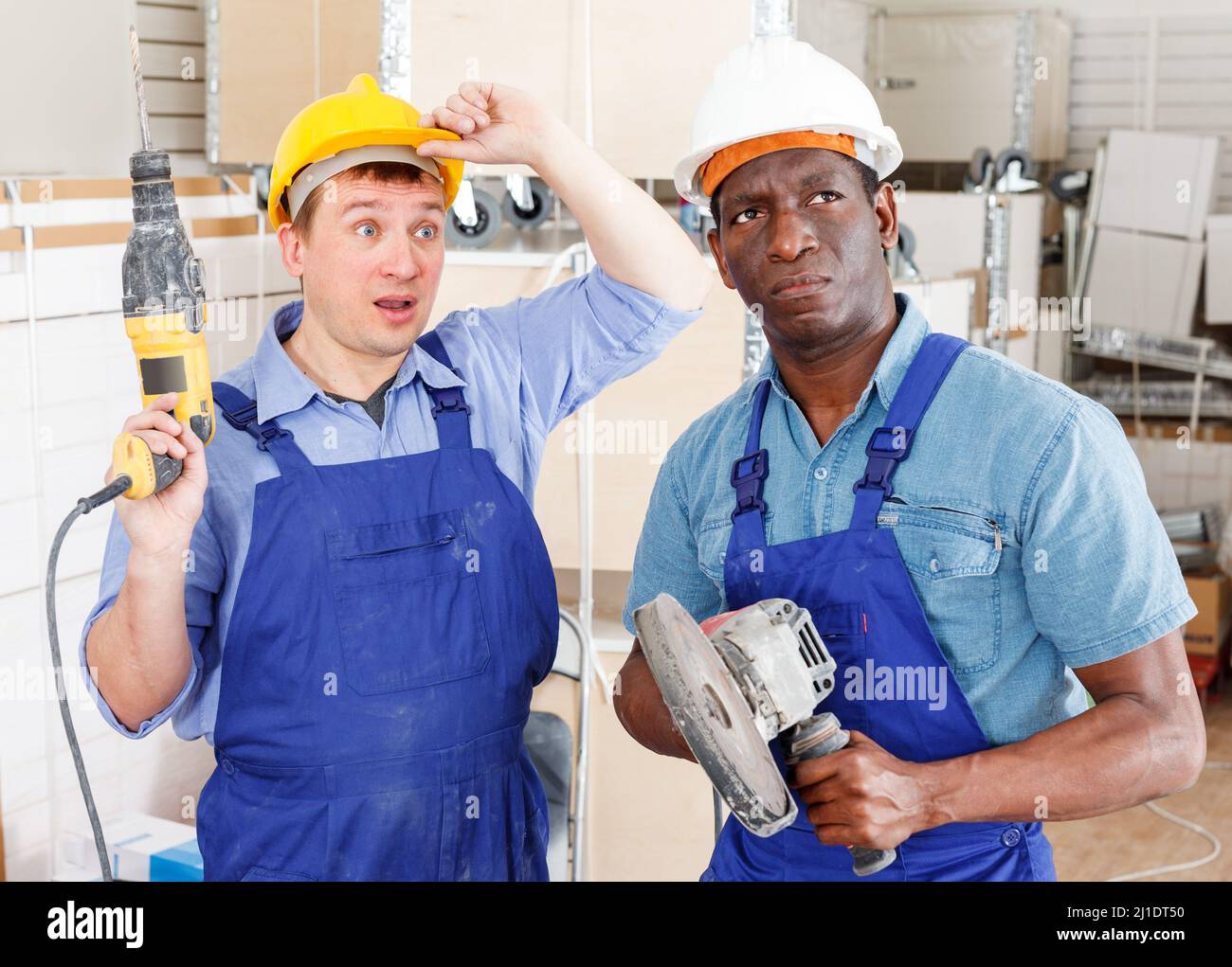 Surprised contractors with power tools Stock Photo
