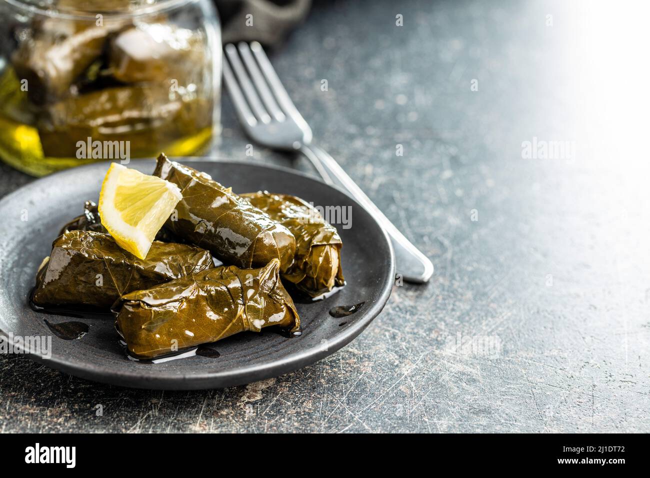 Dolmades. Stuffed vine leaves. Greek appetizer on the plate Stock Photo