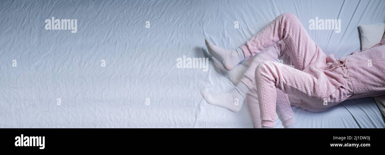 African American Woman With RLS Restless Legs Syndrome. Sleeping In