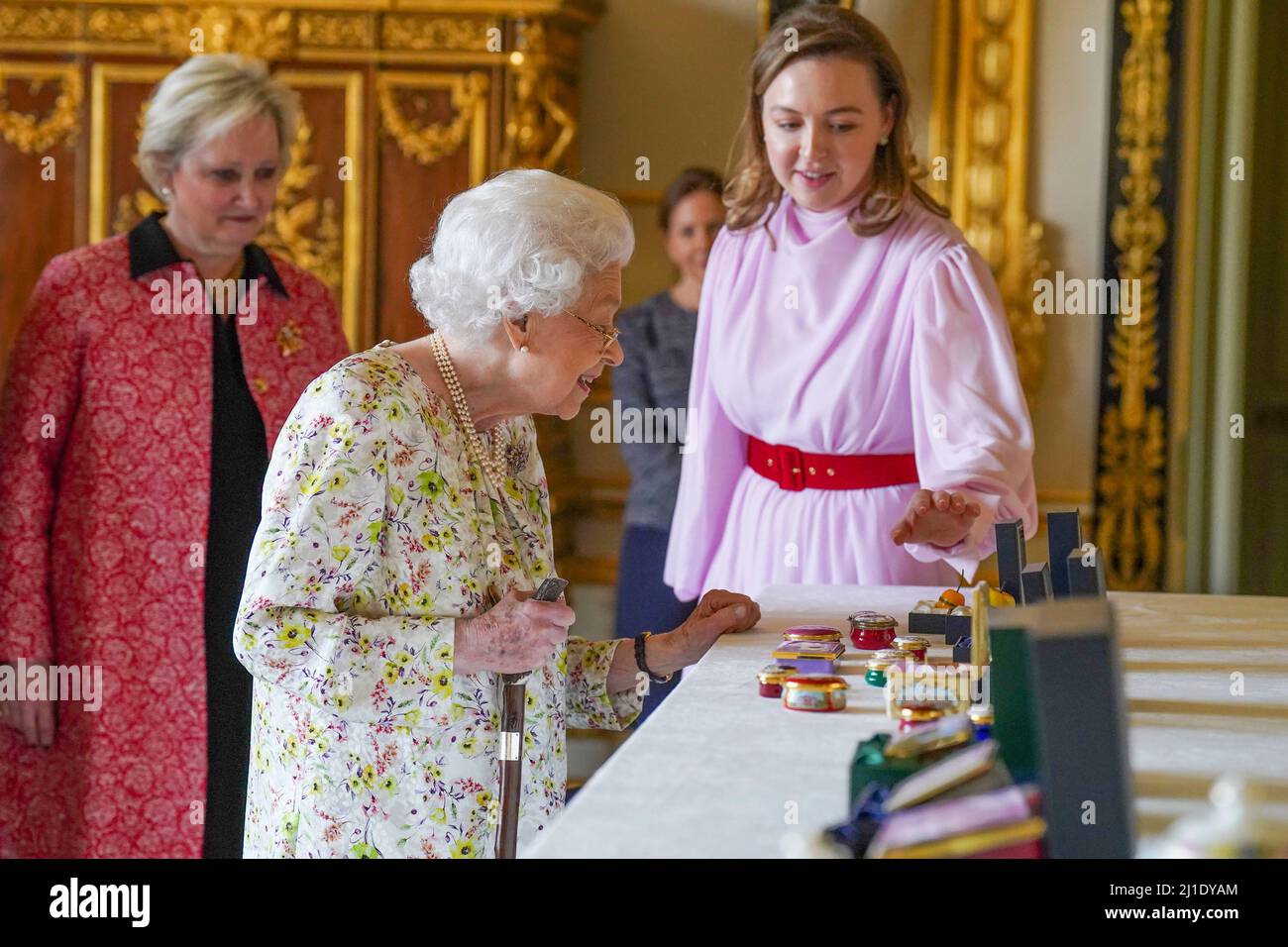 Queen Elizabeth II views a display of artefacts from British craftwork