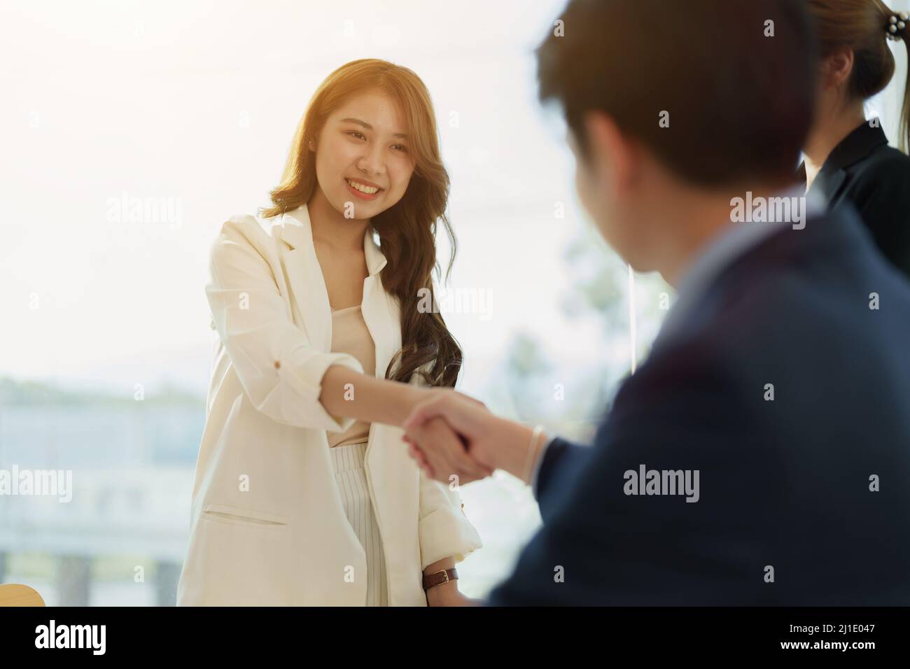 Partnership. asian business people shaking hand after business job interview in meeting room at office, congratulation, investor, success, interview Stock Photo