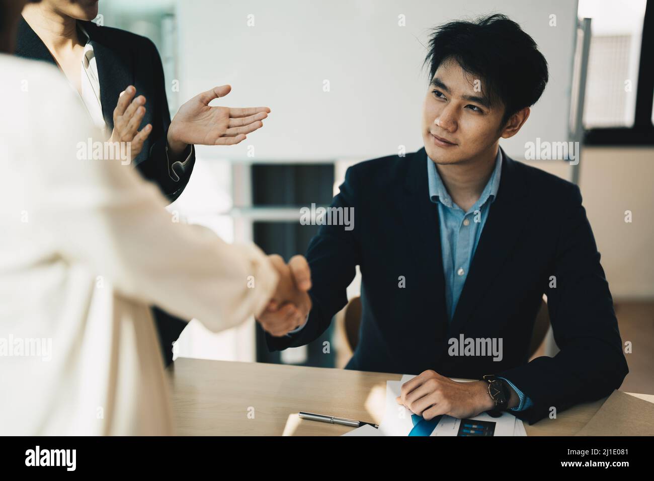 Partnership. asian business people shaking hand after business job interview in meeting room at office, congratulation, investor, success, interview Stock Photo