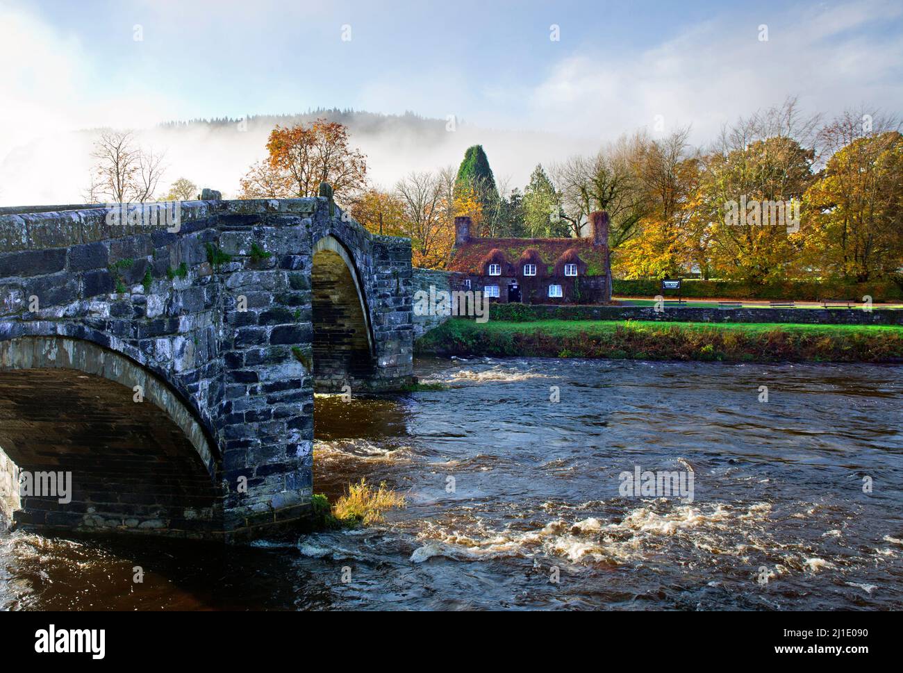 Autumn mists above Pont Fawr Bridge a three arched stone bridge over the River Conwy at Llanwrst Snowdonia National Park Gwynedd North Wales UK Stock Photo