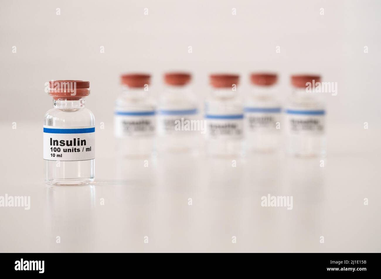 Insulin vials against a white background: properly cooling and storing insulin. Stock Photo