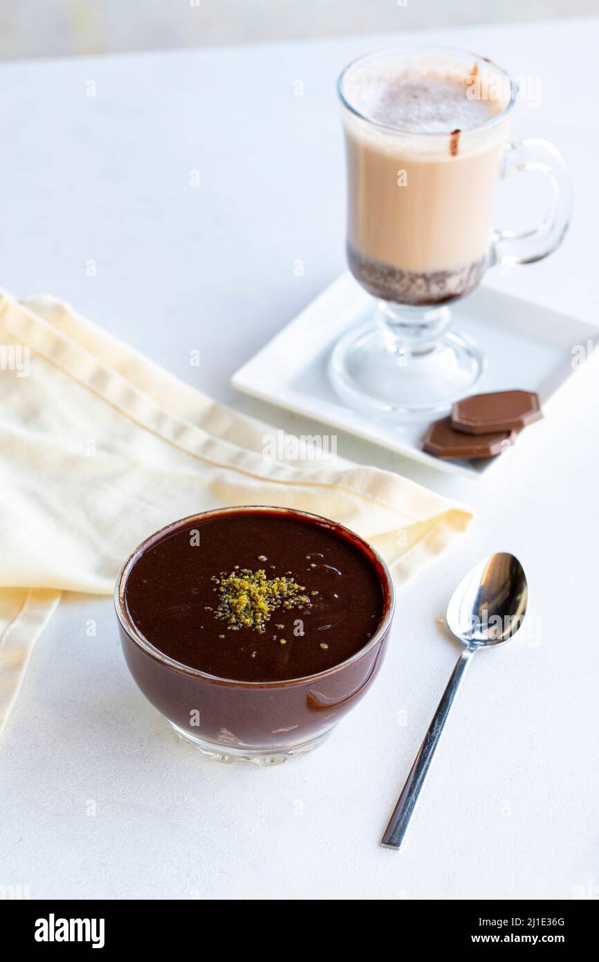 Chocolate pudding or supangle dessert on a white background. With hot chocolate on the side. close up Stock Photo