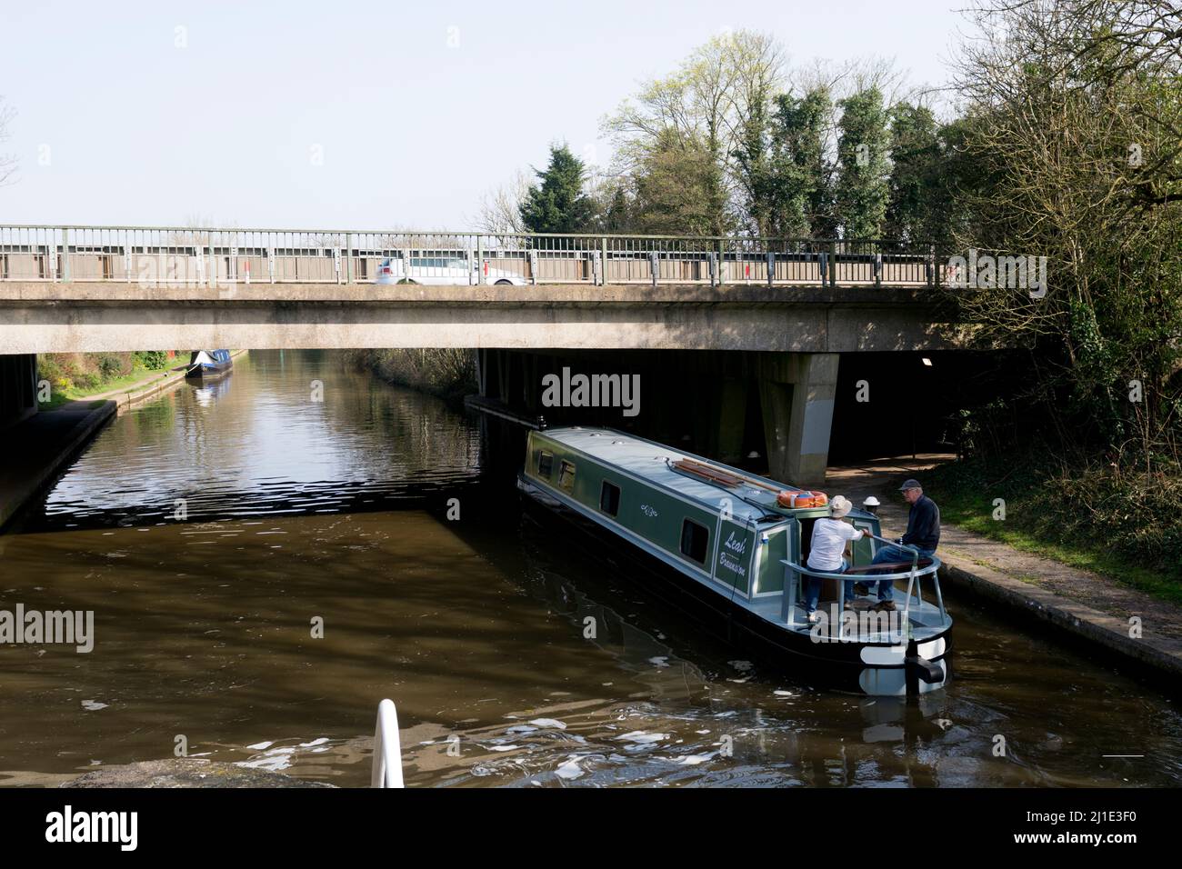 A narrowboat on the Grand Union Canal passing under the A46 road, Warwick, Warwickshire, UK Stock Photo