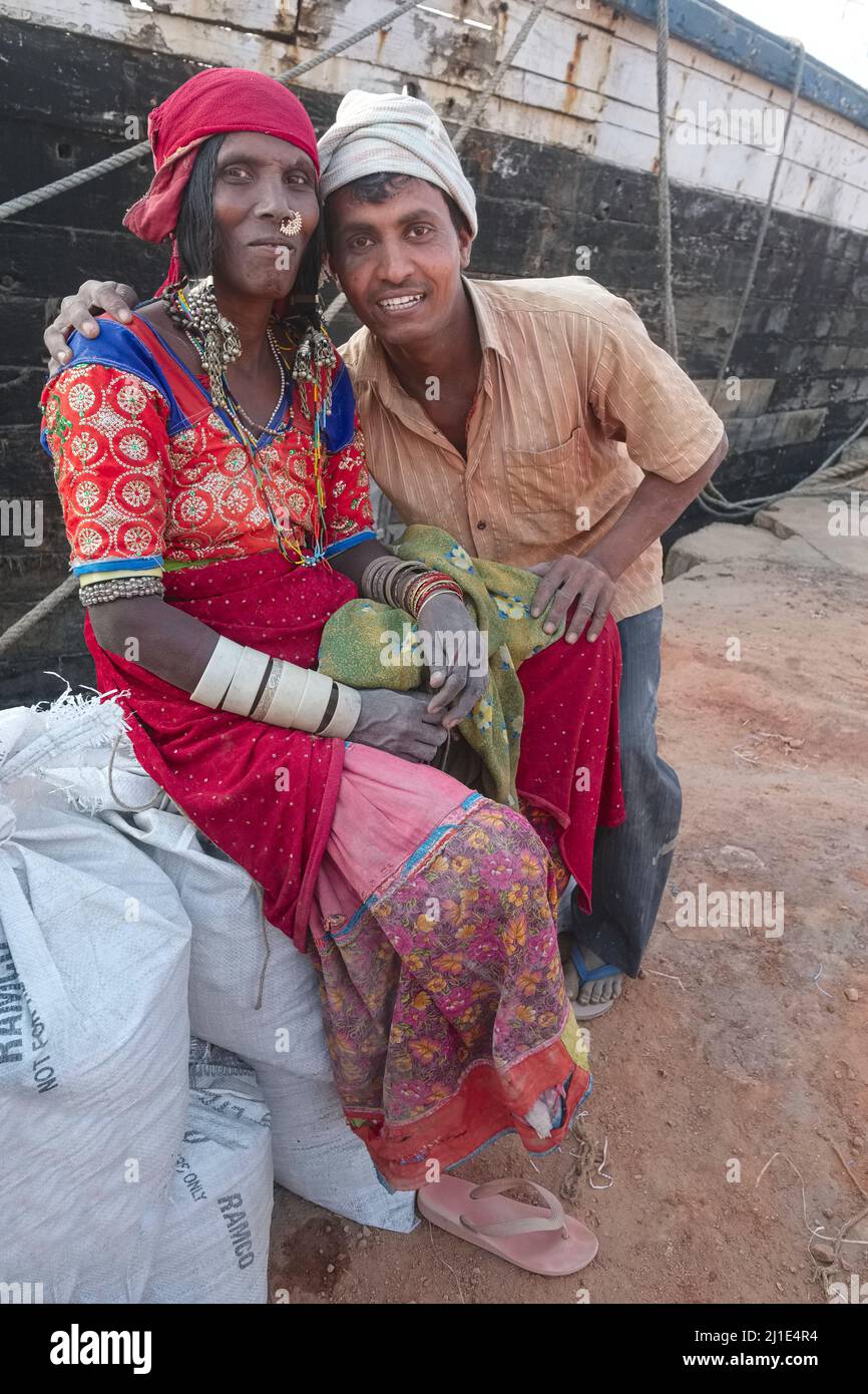 A worker (r) at the Old Port in Mangalore (Mangaluru), Karnataka, South India, poses with a colorfully dressed woman from the Lambada (Lambari) tribe Stock Photo