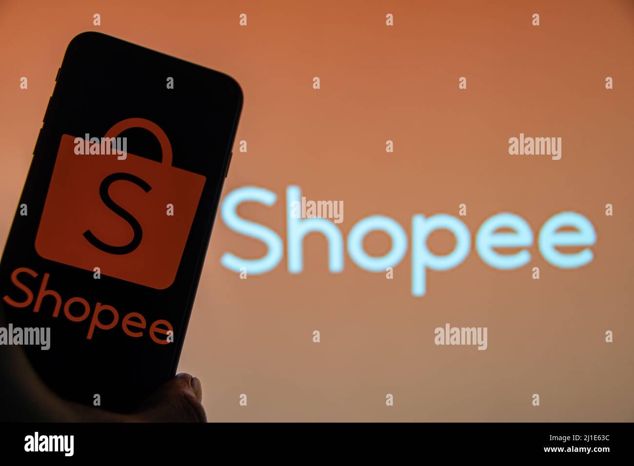 Shopee is e-commerce technology company. Smartphone with Shopee logo on the  screen, shopping cart and parcels Stock Photo - Alamy