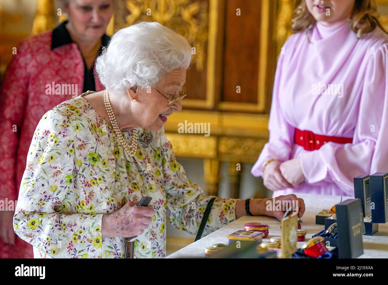 Queen Elizabeth II views a display of artefacts from British craftwork
