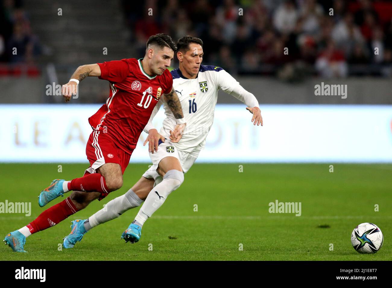 BUDAPEST, HUNGARY - MARCH 24: Dominik Szoboszlai of Hungary competes for the ball with Sasa Lukic of Serbia ,during the international friendly match between Hungary and Serbia at Puskas Arena on March 24, 2022 in Budapest, Hungary. (Photo by MB Media) Stock Photo
