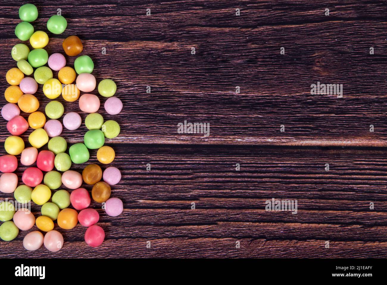 Multicolor candies on a wooden background Stock Photo