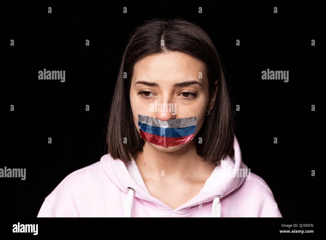 Front camera view. Portrait of young upset girl with three colors duct